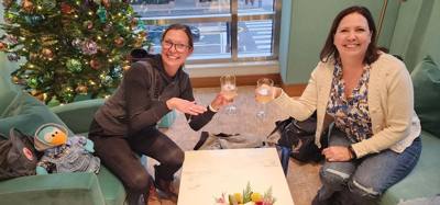 Julie and Lynn admiring and touching the merch...
